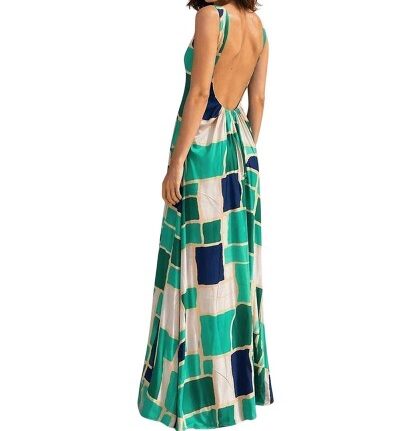 Back view of a woman wearing a sleeveless, backless maxi dress with a green, teal, and blue geometric pattern.