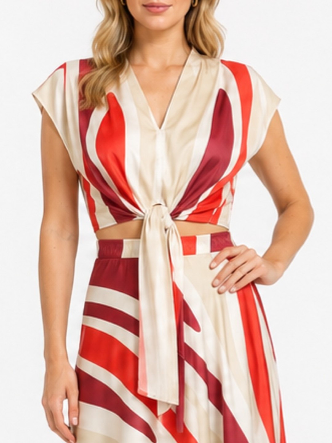 Woman wearing a beige and red striped wrap crop top with a front tie, paired with a matching striped skirt.